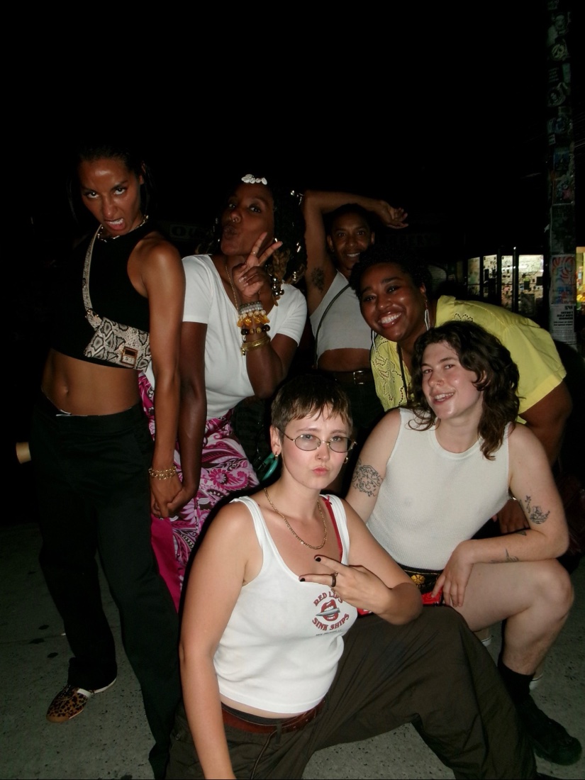 Group of friends posing together at night