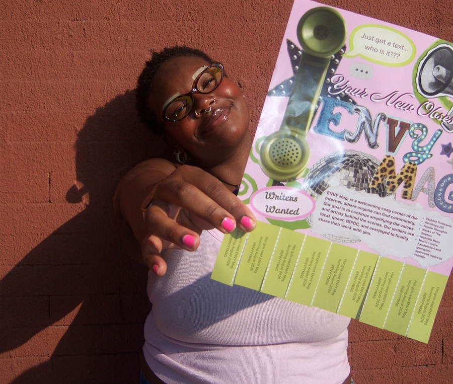 Founder holding up the ENVY flyer